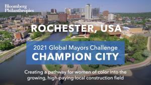 Photo of the skyline in Rochester, Minn. A blue box signifies the city as a 2021 Global Mayors Challenge Champion City with a brief description that reads: “Creating a pathway for women of color into the growing, high-paying local construction field”