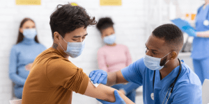 Person is getting prepared to receive vaccine.