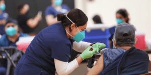 Nurse in Long Beach, Calif, is giving a resident a dose of the COVID-19 vaccine