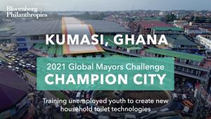 Photo of Kumasi’s skyline. A green box signifies the city as a 2021 Global Mayors Challenge Champion City with a brief description that reads “Training unemployed youth to create new household toilet technologies”