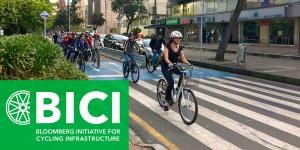 A group of people riding bikes in a cycling lane, with BICI logo