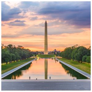 The Washington Monument and Reflecting Pool in Washington, D.C. at sunset.