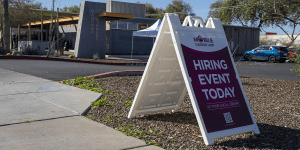 A sign outside the Saguaro Library reading "Hiring event today."  The sign has the logo of the Mobile Career Unit above the other text.