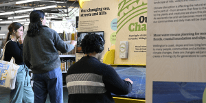 People admiring an exhibit titled "our changing city".