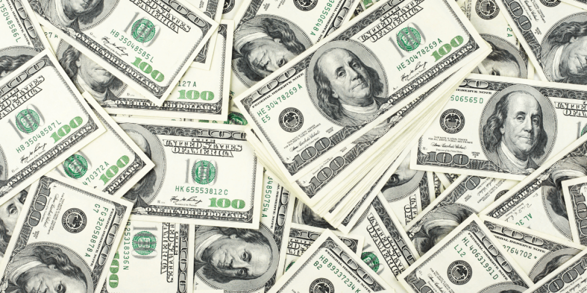 A pile of 100 dollar bills spread out
