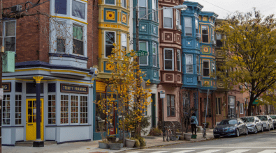 A photo of multi-story row homes along a block in Philadelphia. 