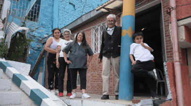 A family stands outside their home in Bogota.