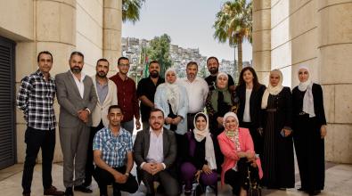 A group photo of the team behind the Amman is Listening program.
