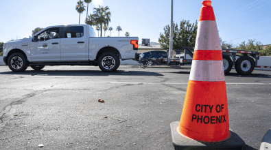 An orange traffic cone with "city of Phoenix" written on it.