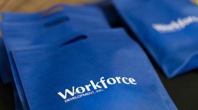 Blue reusable bag with the word "workforce" printed in white.