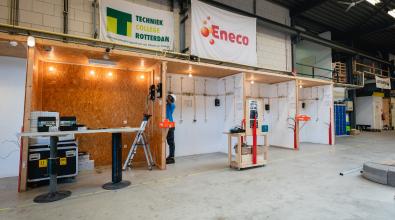 A construction worker building stalls at a marketplace.