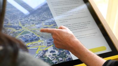 A finger pointing at a map.