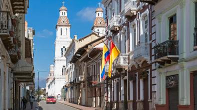 Ecuador, Cuenca, view to row of houses and Santo Domingo church in the background.