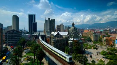 A train speeds through the center of Medellin, Colombia.