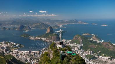 The Christ the Redeemer statue overlooking Rio de Janeiro, Brazil, as seen from the mountains behind the statue.