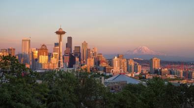 The sunset casts a golden glow over Seattle, Washington.